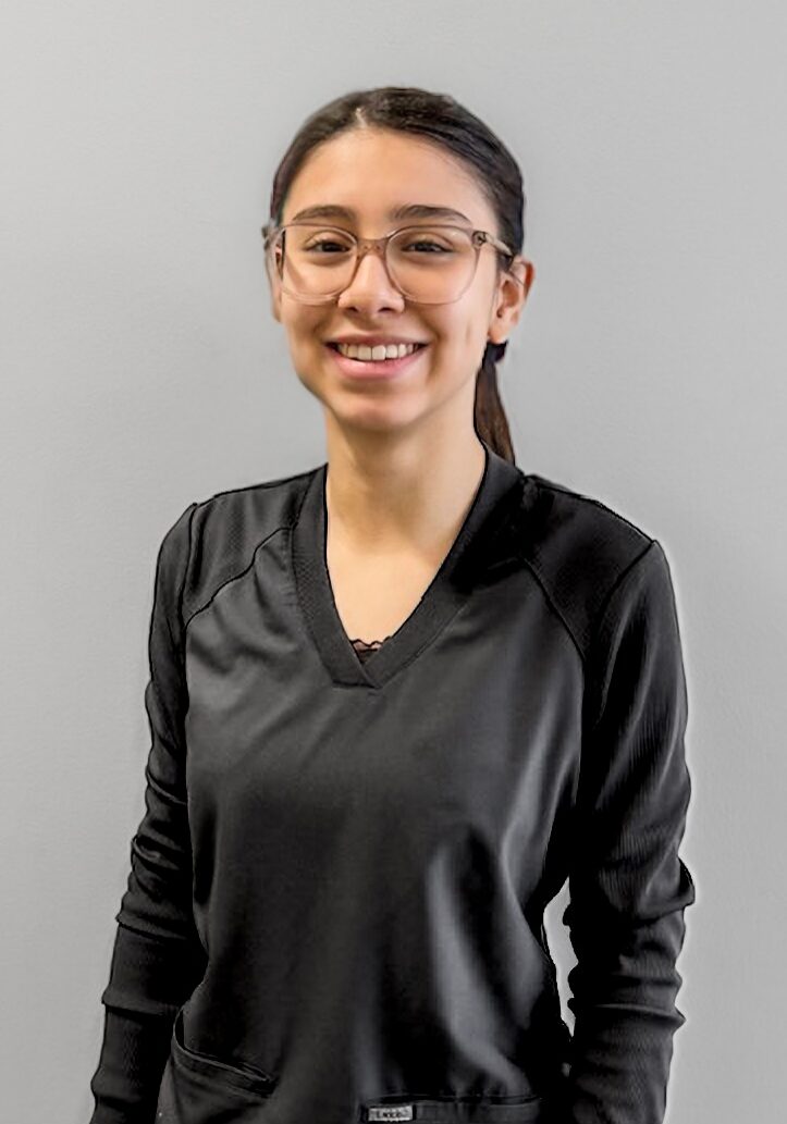 Karen - Sterilization Processor Karen, sterilization processor at Klein Walker & Weber Orthodontics, smiling in a black scrub top against a gray background.