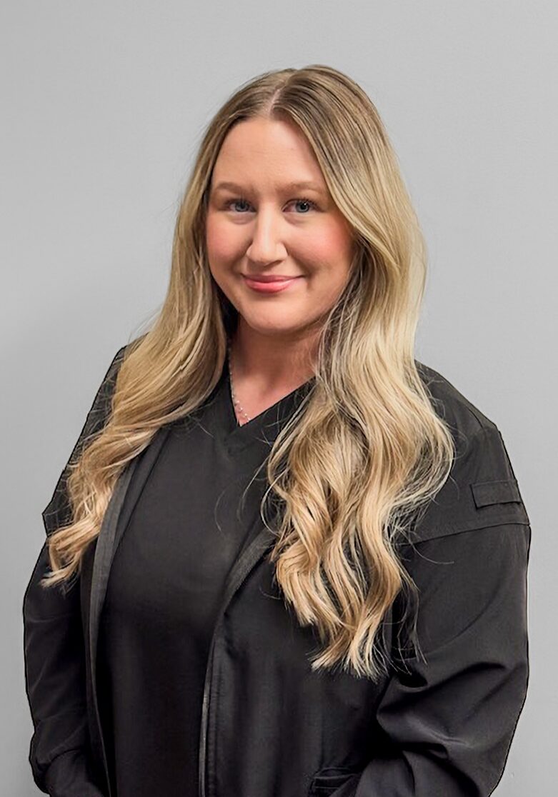 Rachel - Front Desk Rachel, front desk staff at Klein Walker & Weber Orthodontics, smiling, wearing a black uniform, against a neutral background.