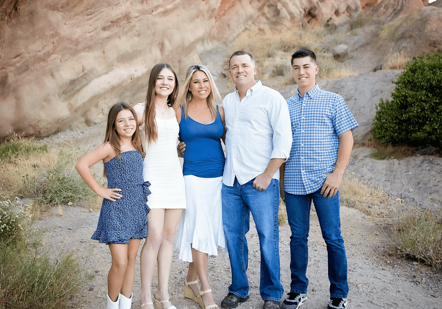 Family portrait of Dr. Peter Weber with his wife and three children outdoors, showcasing their connection and community involvement.